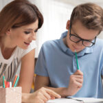 Mom helping teenager with schoolwork
