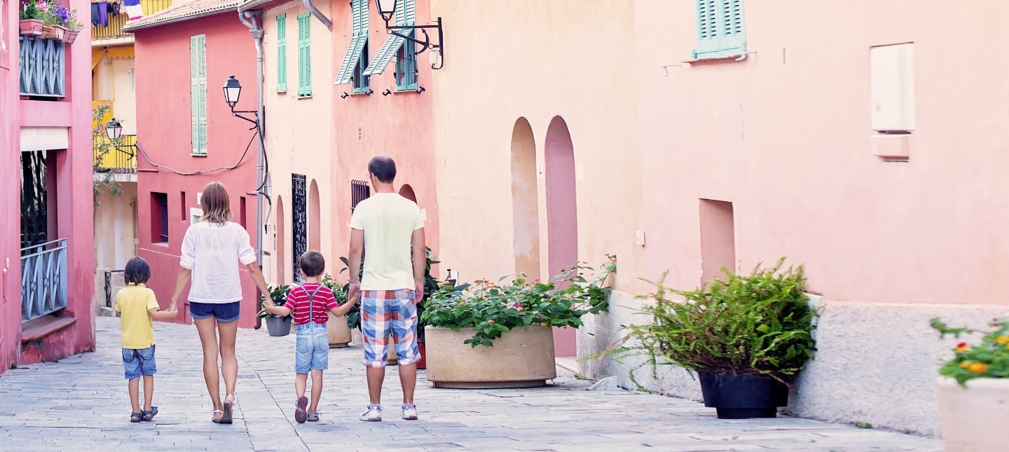 family holding hands in a colorful city