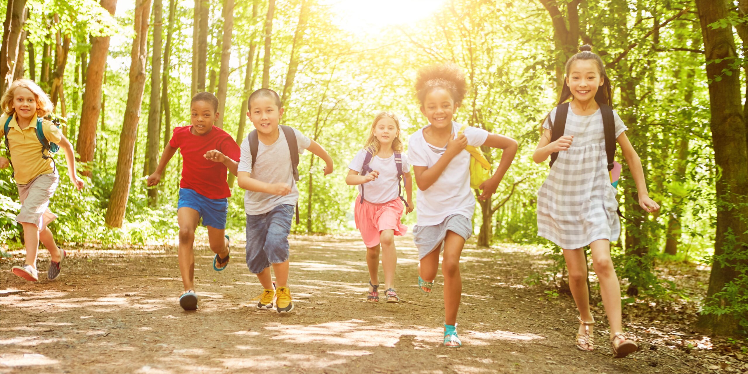Children running on a nature trail