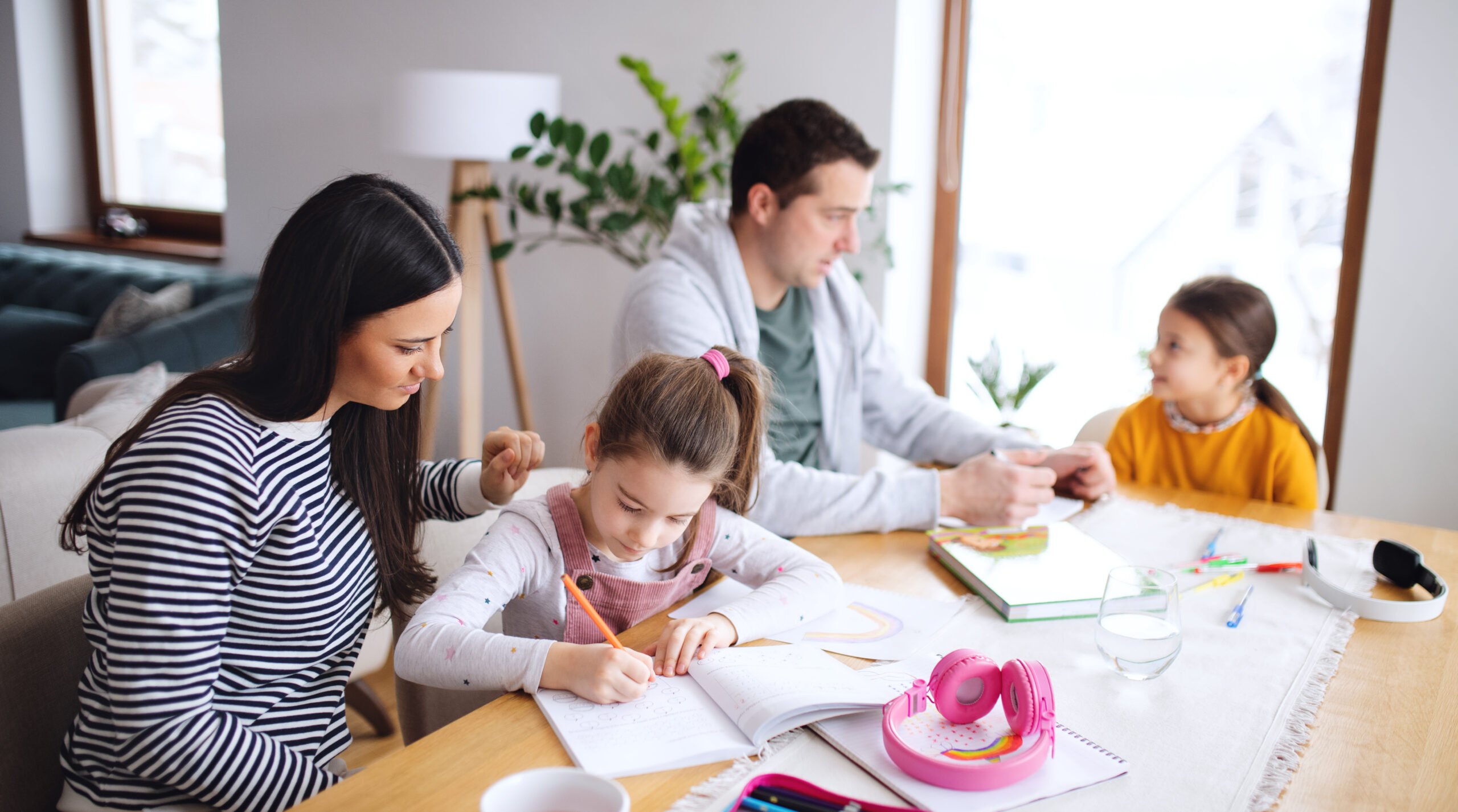 family of four studying at the kitchen table