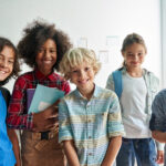 A group of children learning and smiling.