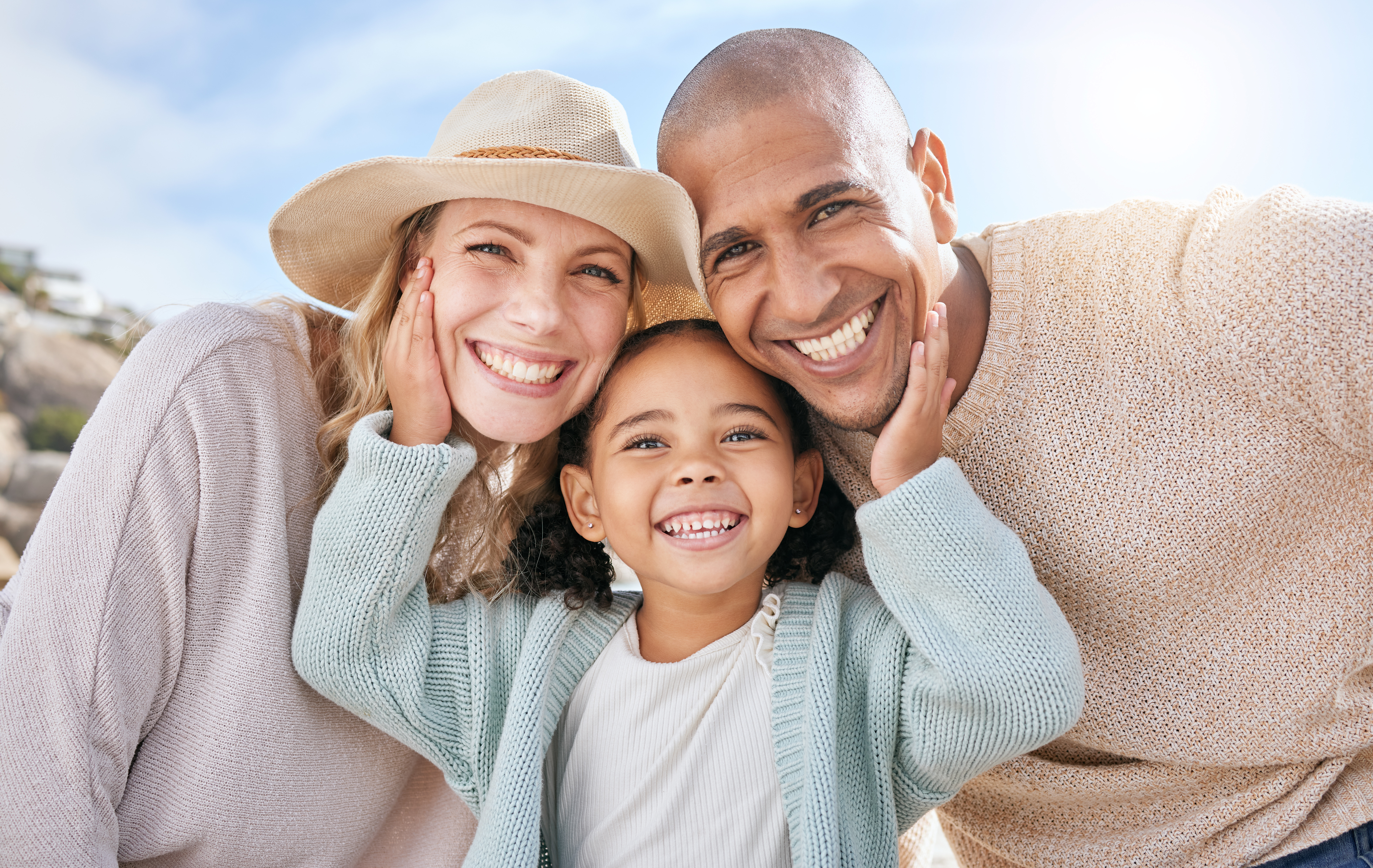 Family, smile and face portrait in nature on holiday, vacation or summer trip. Diversity, travel and parents, father and mother with girl, love and care, spending quality time together and bonding