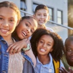 A group of homeschool children smile at the camera