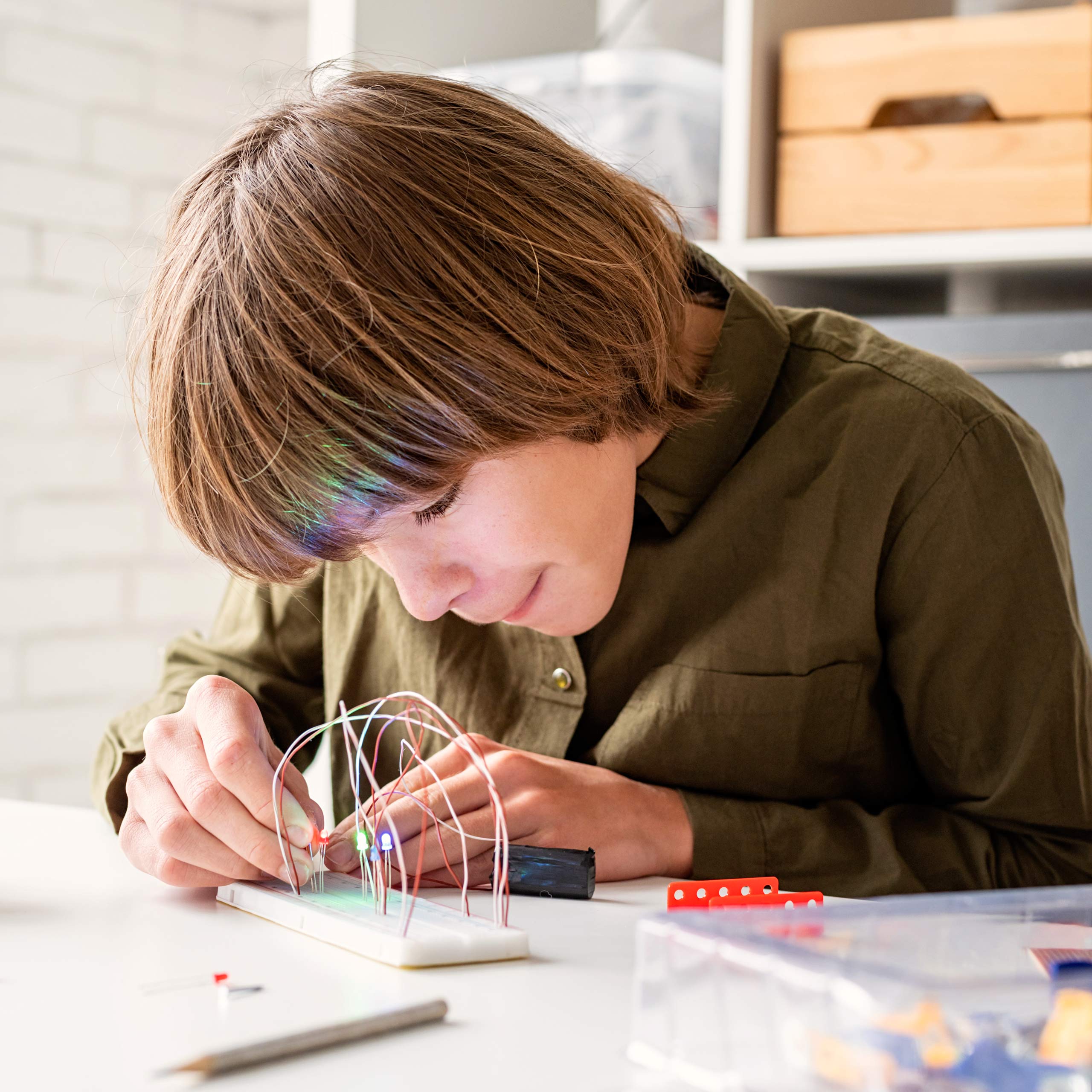 boy working on an electricity project for school