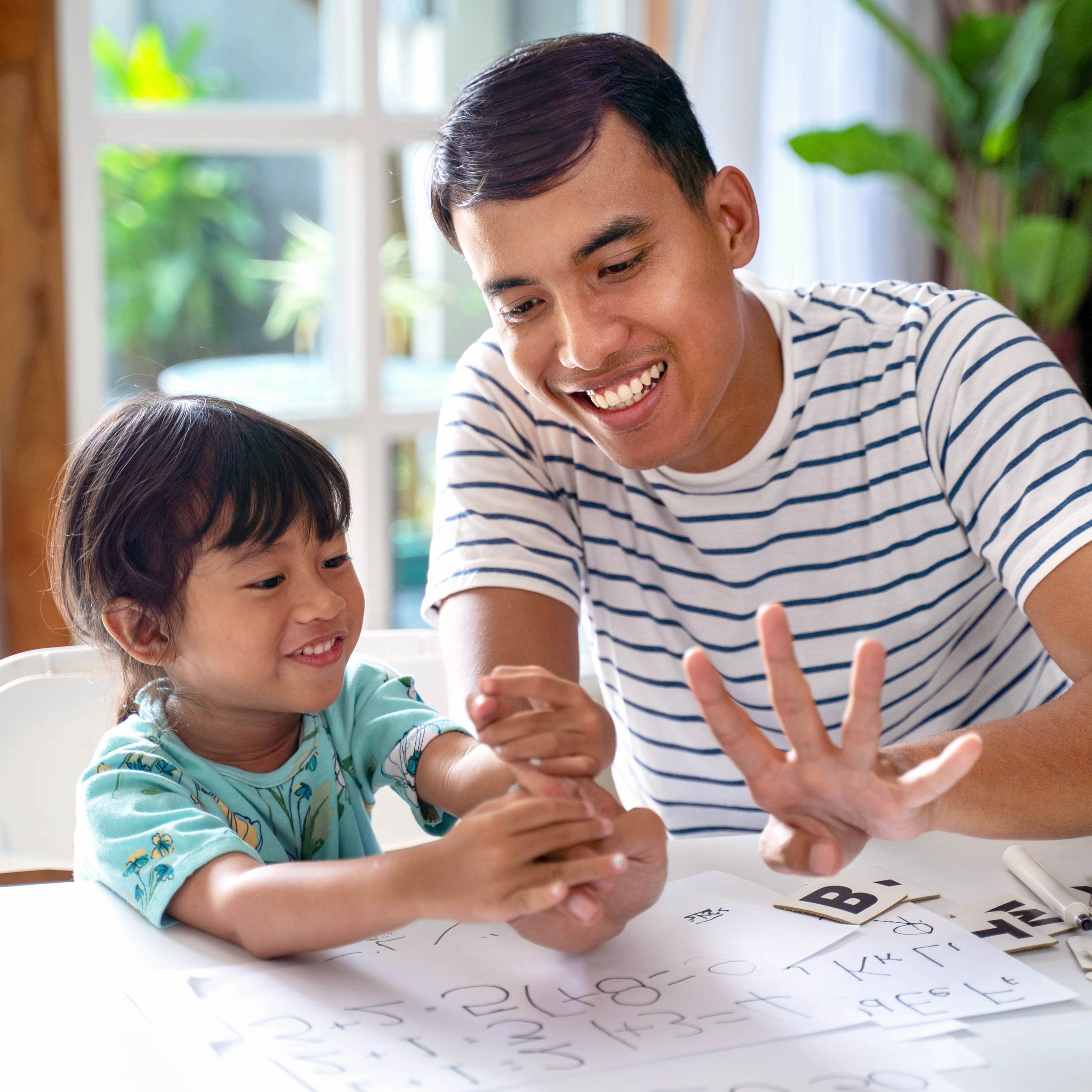 toddler learning math and counting with her father