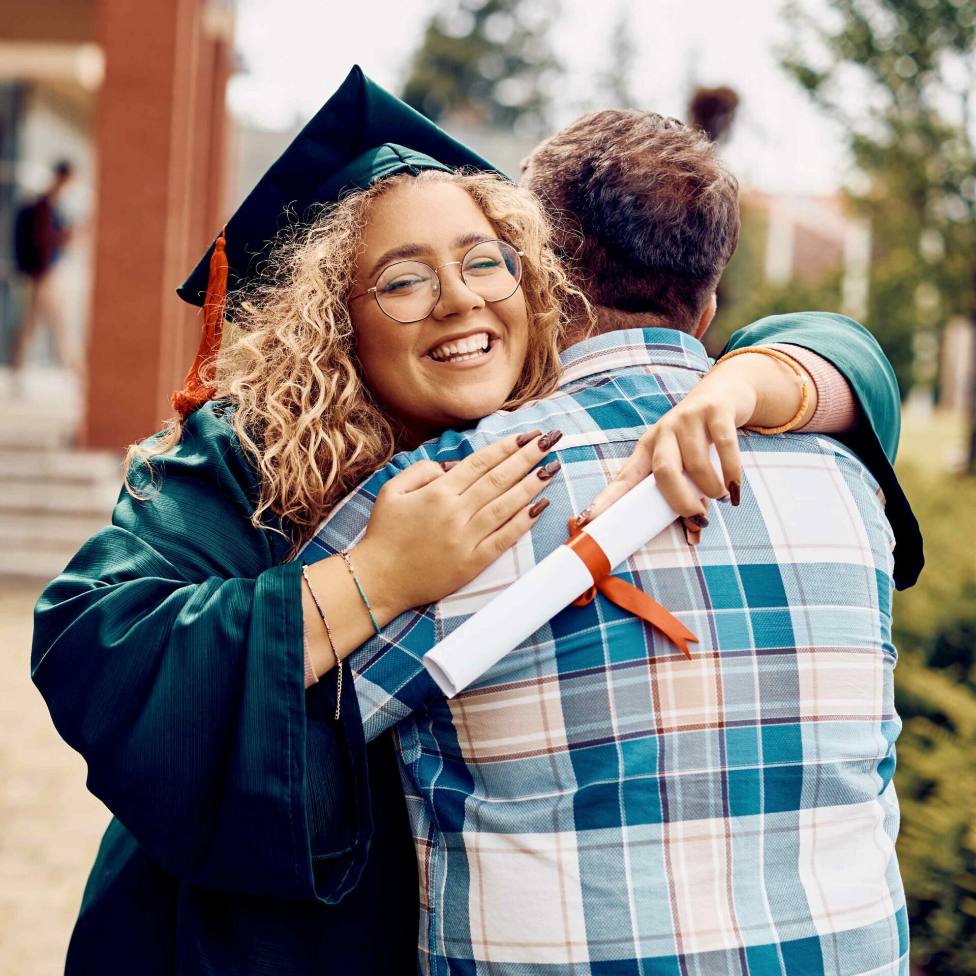 Student hugging dad at graduation