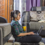 A girl with a laptop takes homeschool courses online.